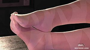 Goddess in pantyhose teases with her legs and toes